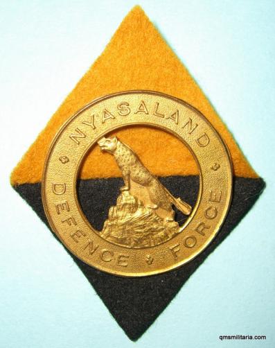 WW2 Nysaland Defence Force Gilt Cast Cap Badge with Diamond Backing Cloth