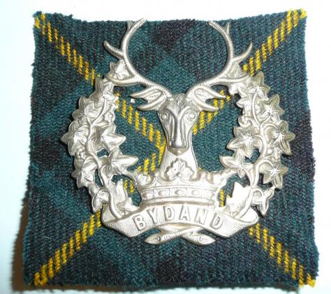 The Gordon Highlanders White Metal Glengarry Cap Badge with  correct Tartan Backing