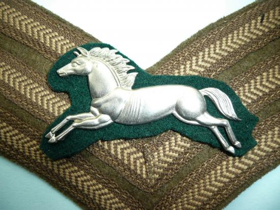 5th Royal Inniskilling Dragoon Guards NCOs White Metal Arm Badge as worn mounted on Sergeants chevrons