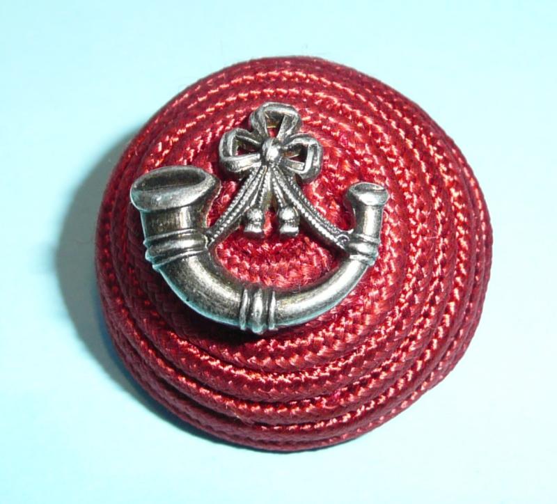 An officer's red cord boss cap badge for the Light Infantry